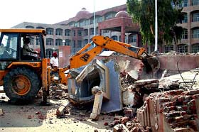 A bulldozer removes unauthorised structures in Bathinda