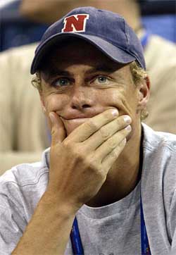 Lleyton Hewitt of Australia watches his girlfriend Kim Clijsters play Justine Henin-Hardenne