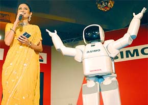 A hostess talks to the media during a Pres conference at the launch of Honda's ASIMO robot 