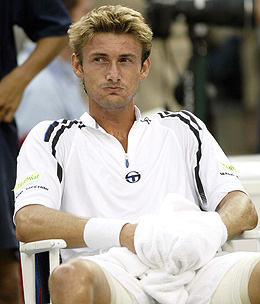 Juan Carlos Ferrero of Spain sits during a break of the men's final against Andy Roddick of the US