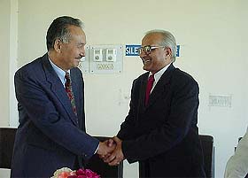 Mr Tashi Dawa, Chairman of the HPSSS Board, shakes hands with Mr H.K. Sharma, new member of the board, after the swearing-in ceremony at Hamirpur