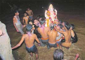 An idol of Lord Ganesha being immersed in the Sutlej on the occasion of Ganesha mahotsav