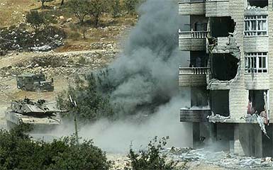An Israeli army tank shells a Palestinian building during a military operation against suspected Palestinian militants in the West Bank city of Hebron