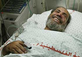 Hamas leader Mahmoud al-Zahar smiles from his hospital bed in Gaza City 