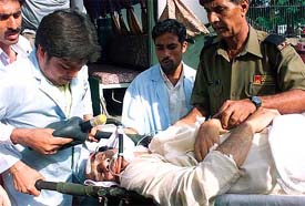 Medical attendants airlift a victim shot by militants in Jammu on Wednesday