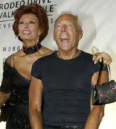 Actress Sophia Loren poses with legendary fashion designer Giorgio Armani 