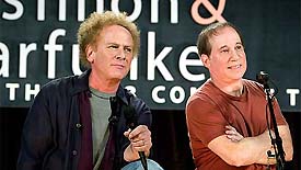 Musicians Paul Simon and Art Garfunkel talk to reporters at a news conference in New York 