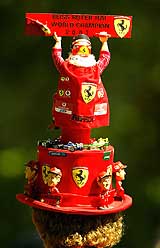 A Ferrari fan wears a hat during the first practice session