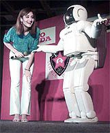 Worlds most advanced humanoid robot Asimo dances with a girl at the National Science Centre in New Delhi 