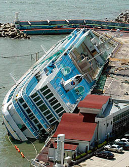 A ship that has been converted into a hotel lies on its side after a typhoon pounded the southern port city of Pusan