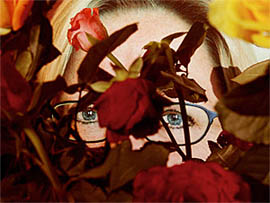 Picture of slain Swedish Foreign Minister Anna Lindh is covered with flowers outside the store where she was stabbed