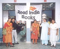 Pratham Delhi's volunteers displaying the ‘Read India Books’ logo.