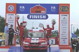 Armin Kremer (right) and co-driver Fred Berseen of Germany on the podium after finishing first in group N at the Rally Hokkaido