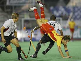 Spain's Eduardo Turbau tumbles beside Germany's Timo Weiss and Michael Green during the European Nations Cup final in Barcelona