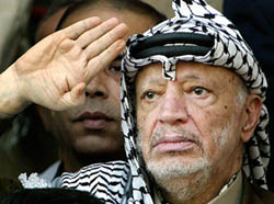 Palestinian President Yasser Arafat salutes during a rally in the West Bank city of Ramallah
