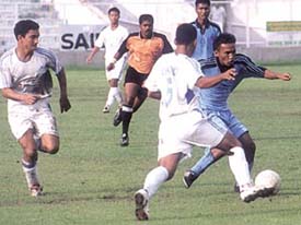 Air Force and Simla Youngs players battle it out for the ball in a DSA Senior Division Football League match at the Ambedkar Stadium on Monday. Air Force won by a lone goal. 