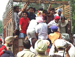 Students arrested while agitating in front of the Punjabi University gate being taken away by the police