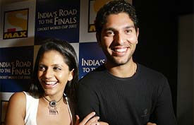 All-rounder Yuvraj Singh and television star Mandira Bedi pose for photographers at the launch of a television program on cricket