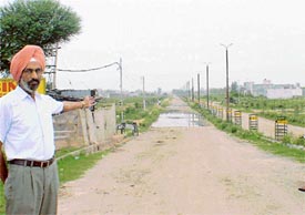 Maj-Gen S.S. Jwanda shows a road in bad shape at Guru Amar Dass Nagar