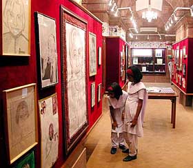 Schoolchildren watch art works presented to the President by children at the Gift Gallery
