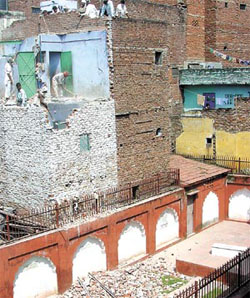 MCD workers demolishing an unauthorised construction near Mazar-e-Zauq, following the Supreme Court order in the Capital