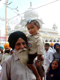 An old man with his grandson at the Jor Mela at Guru Ki Dhab in Faridkot