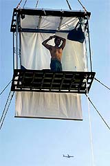 US illusionist David Blaine looks out from his box