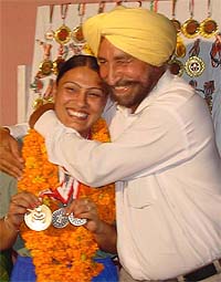 Powerlifter Mandeep Kaur is hugged by her father, Mr Mohinder Singh