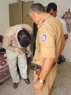 Sleuths of Delhi Police Crime Branch looking for fingerprints at the residence of a Delhi Government Eye Surgeon after a break-in at DDA Flats complex in Motia Khan 
