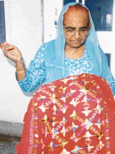 A woman engaged in phulkari work in Tripuri