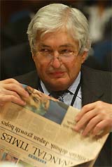 World Bank President James Wolfensohn at reads a financial newspaper prior to a G24 finance meeting at the Dubai Convention Centre