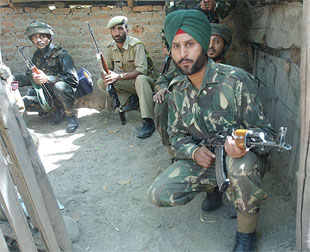 Jawans take position during a gunfight 