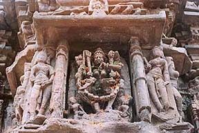 Floral offerings on a carved deity
