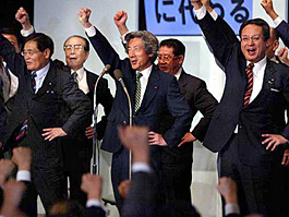 Japanese Prime Minister Junichiro Koizumi raises an arm with other candidates to give a pep up slogan following his re-election as President of the ruling Liberal Democratic Party at the party headquarters in Tokyo