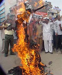 The Cable Upbhokta Sangharsh Committee members burn an effigy of the local cable operators