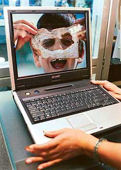 A model demonstrates Sharp Corp's new laptop computer "Mebius PC-RD3D" equipped with an original 3D LCD to see three-dimension images at the WPC Expo 2003 in Chiba, northeast of Tokyo.
