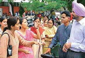 Students make a point before PUSU president Malwinder Singh Kang (extreme right) during a protest organised against the alleged misbehaviour of a college teacher at Government College for Girls, Sector 11, in Chandigarh on Monday.
