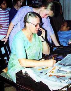 Gladys Staines, widow of Australian missionary Graham Staines, talks on phone as her daughter looks on after a court sentenced the main accused Dara Singh to death in Bhubaneshwar 