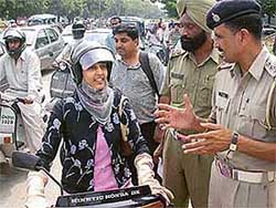 One of the recipients of the award, Ms Manmeet Kaur, tells the cops why she chose to wear a helmet at the Press Chowk