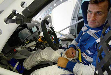 Italian motor racer Alex Zanardi sits in his BMW 320i racing car during a test drive at Italy's Monza race track 
