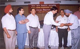 Mr V.K. Gupta, Deputy General Managar, PNB, distributes loan cheques among customers at a function