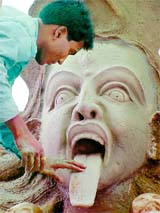 An artist makes an idol of Kali on the eve of Navratri festival in Bhopal 
