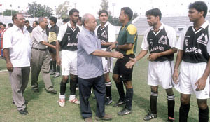 Delhi Soccer Association president Nawabuddin Zaheer and secretary N. K. Bhatia meeting players before the start of the Lt. Governors Cup Football Tournament at the Ambedkar Stadium.
