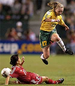Australia's Danielle Small leaps over Chinese defender Liping Wang during their first round match at the Womens World Cup