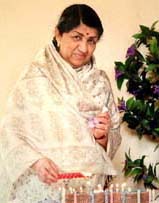 Melody queen  Lata Mangeshkar lights candles on the eve of her 75th birthday in Mumbai