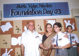 Head girl Divya Bhojwani receiving the All-Round Best Award from Prof M. M. Pant.