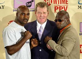 Former heavyweight champion Evander Holyfield of Atlanta, Georgia, and IBF cruiserweight champion James Toney of Los Angeles pose with boxing promoter