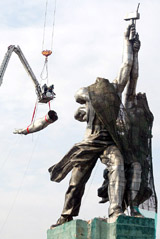 Russian workers dismantle the statue in downtown Moscow