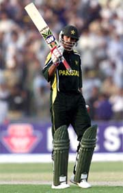 Pakistan's Shoaib Malik waves his bat to acknowledge the crowd 