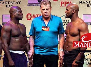 Boxing promoter Dan Goossen stands between James Toney and Evander Holyfield 